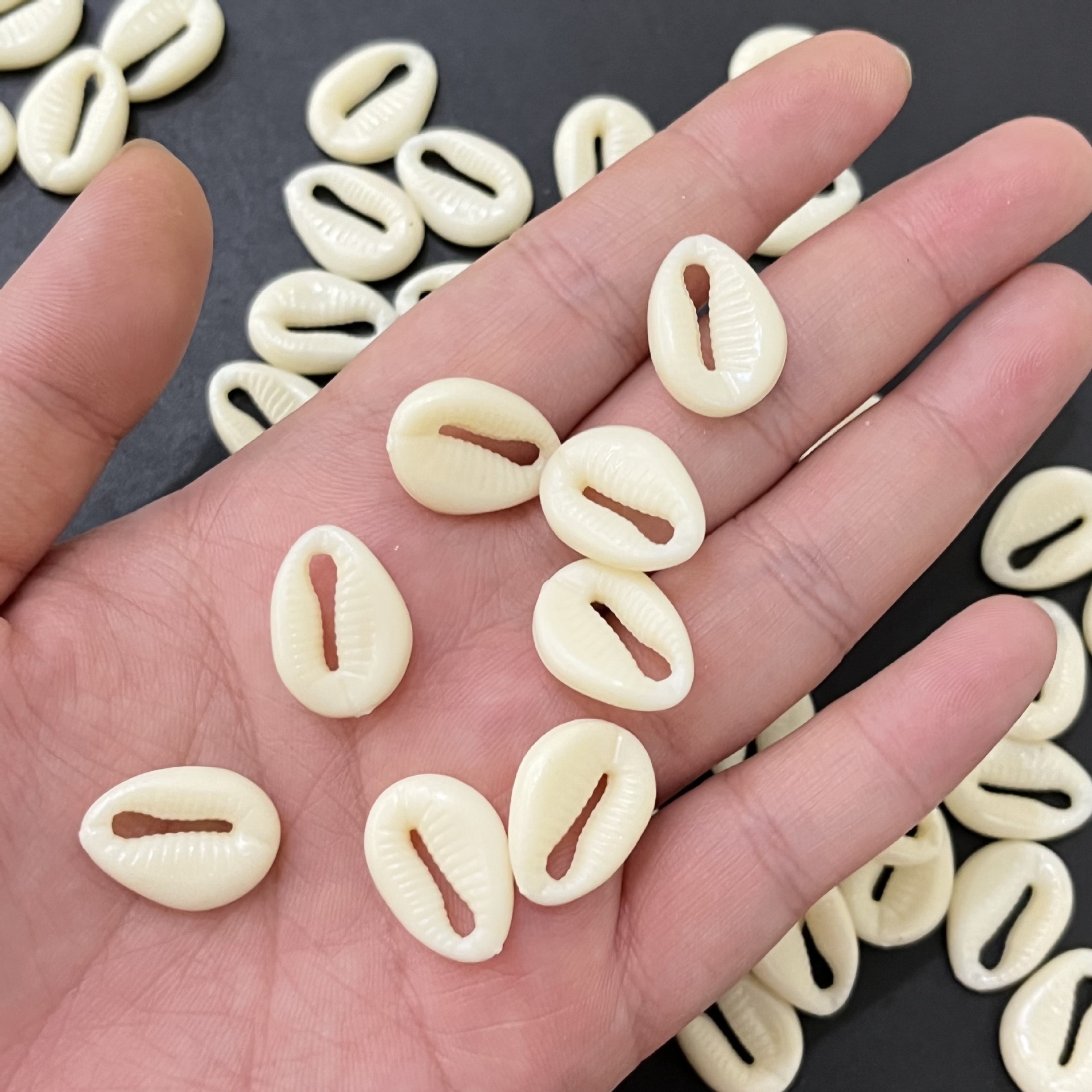 DIY jewelry and necklace manufacturer with beige shell perforated plastic beads