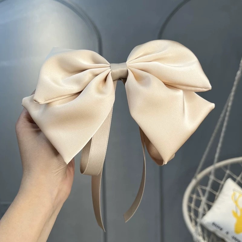 A large bow hairpin for children is stuck on the back of the head of a wine-red little girl princess for the New Year. A ribbon hairband is a cartoon hairband Item Picture