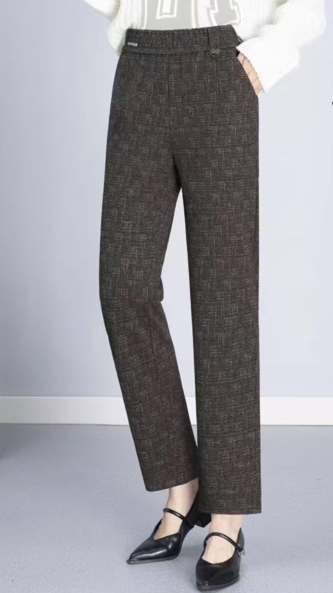 In the autumn and winter of 2025, this is a trendy women's trousers with a small leg, elastic waist, faux wool, and coffee-gray color details Picture