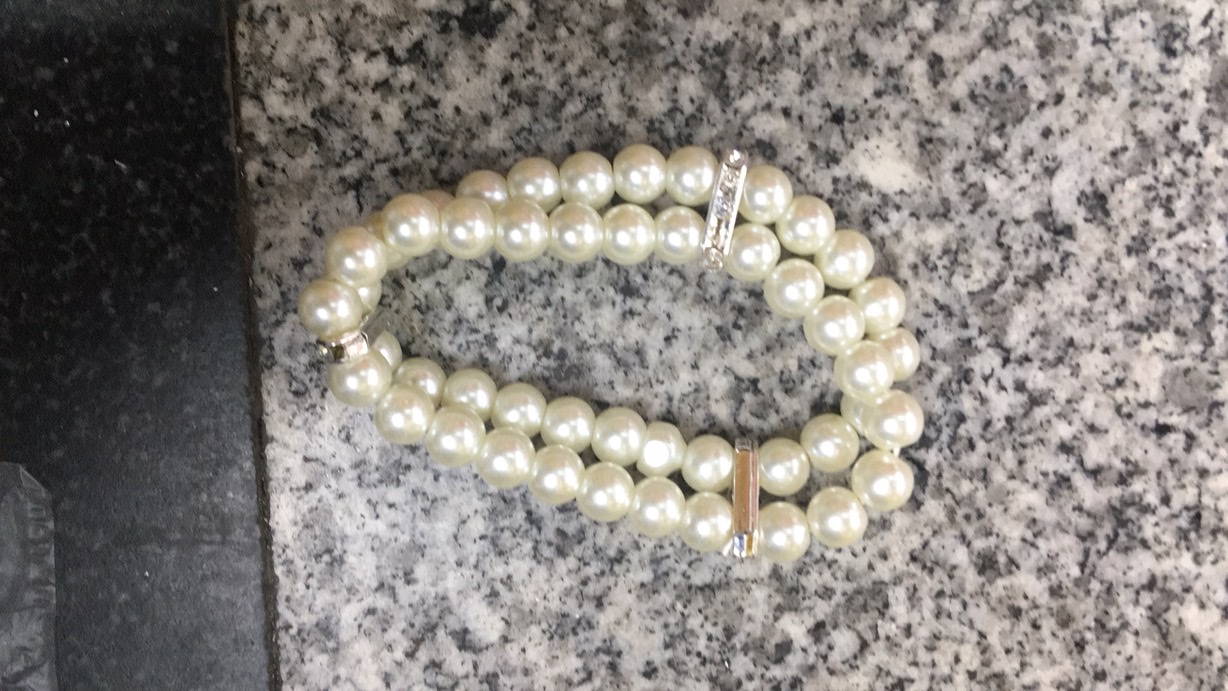 This is a fashionable bracelet for both men and women. It is made of glass and is simple and versatile