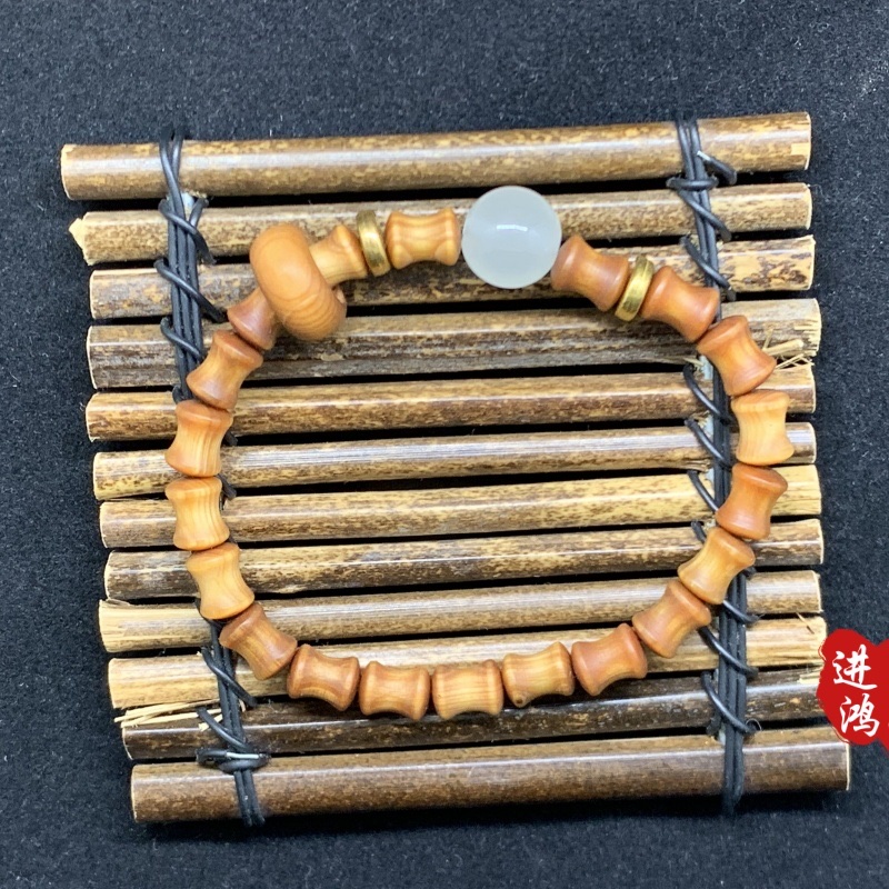 This Chinese-style high-oil blood dragon wood bracelet is a new Chinese-style sandalwood bamboo joint bead plain ring cultural play Buddhist prayer bead bracelet woven. The bamboo control shape high-oil blood dragon wood bracelet is paired with jade beads, presenting a simple and elegant appearance and showcasing the charm of Eastern aesthetics This Chinese-style high-oil blood dragon wood bracelet is a new Chinese-style sandalwood bamboo joint bead plain ring cultural play Buddhist prayer bead bracelet woven. The bamboo control shape high-oil blood dragon wood bracelet is paired with jade beads, presenting a simple and elegant appearance and showcasing the charm of Eastern aesthetics