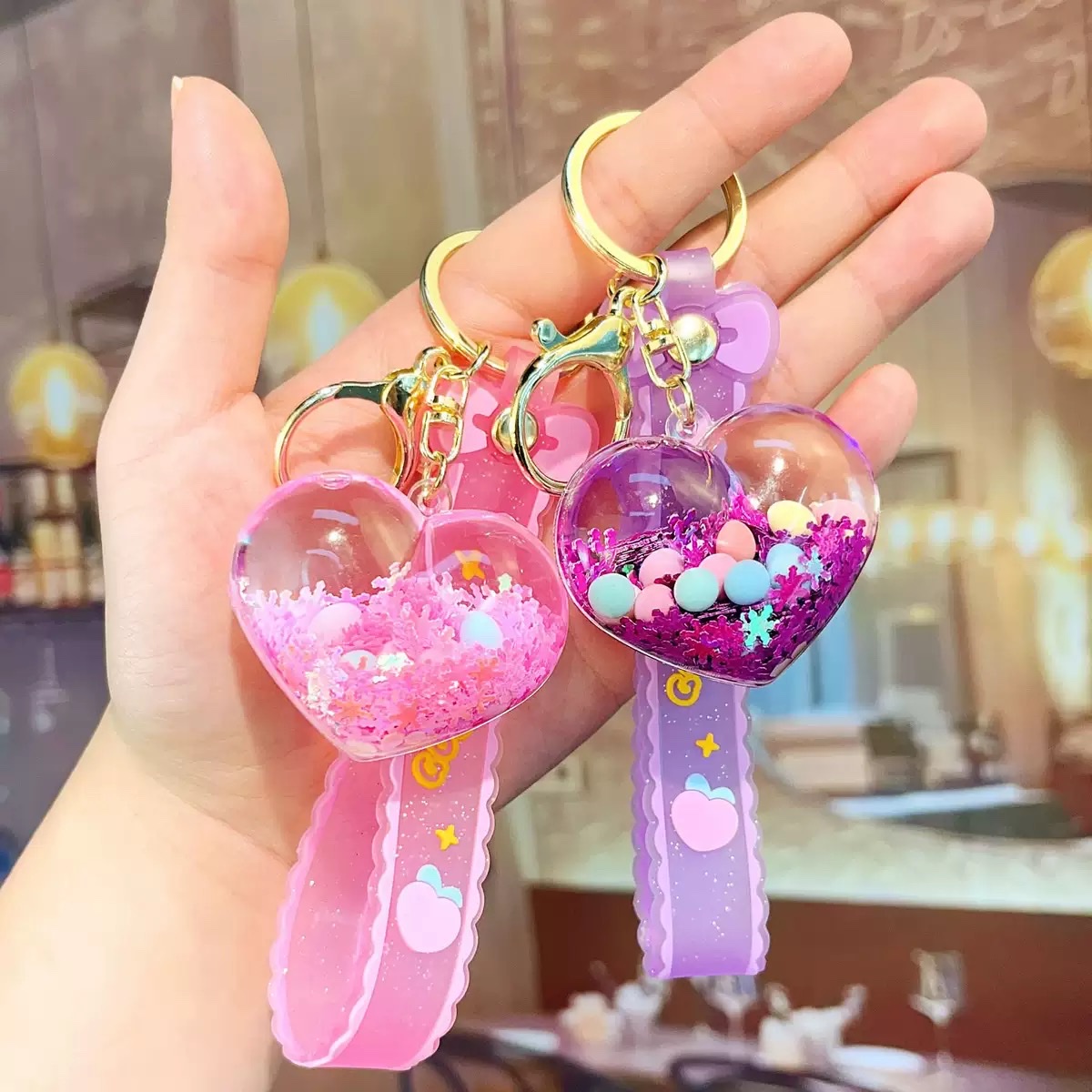 Creative acrylic illuminated heart keychains, liquid oil flowing sand key chains, car pendants and decorations wholesale blind boxes details Picture