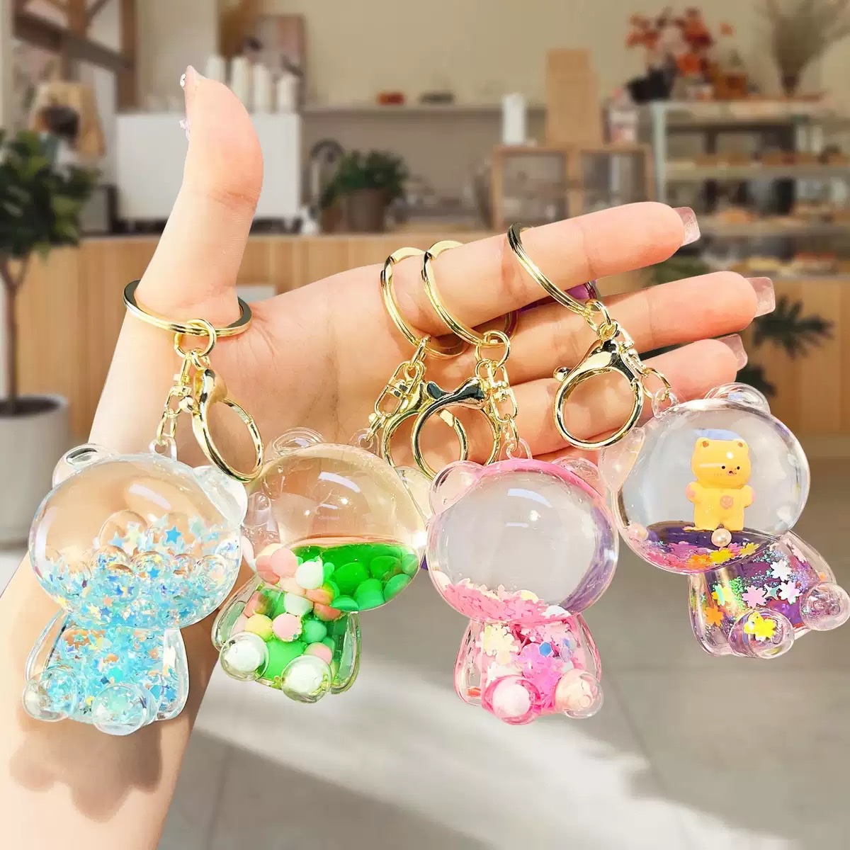 Creative oil sugar bean violent bear keychain pendant, acrylic flowing sand bottle bag pendant, small claw machine gift wholesale detail image 3