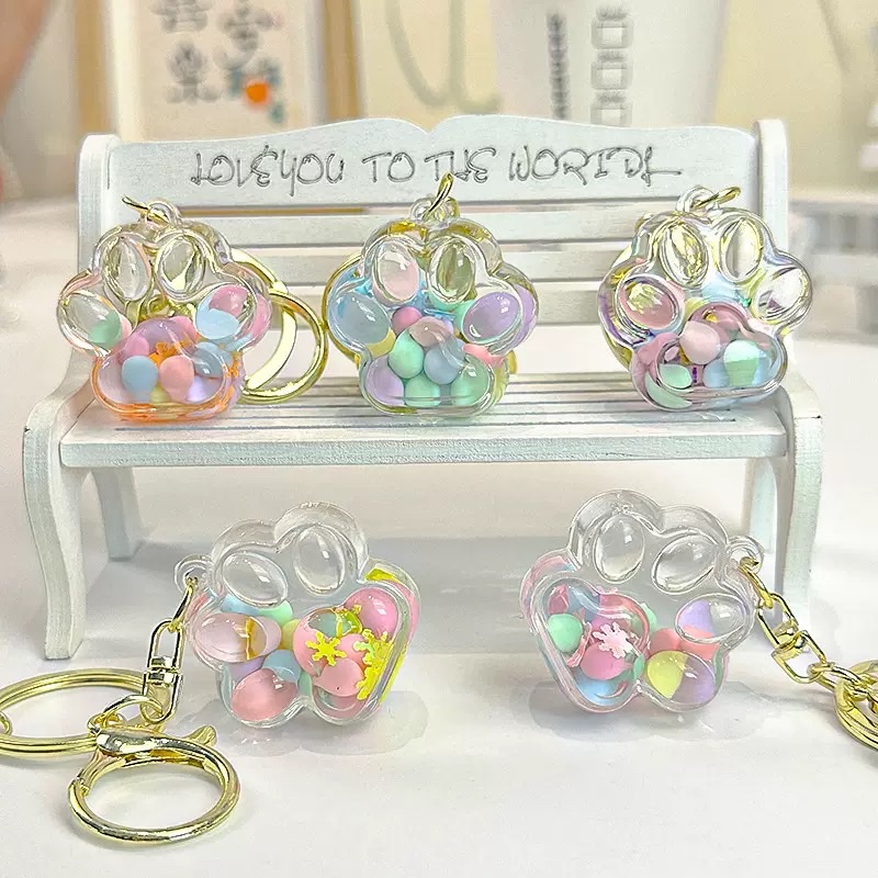 Wholesale of new oil-filled flowing sand keychains, cat paw drift bottles, flowing sand pendants, car cartoon key chains and small gifts details Picture