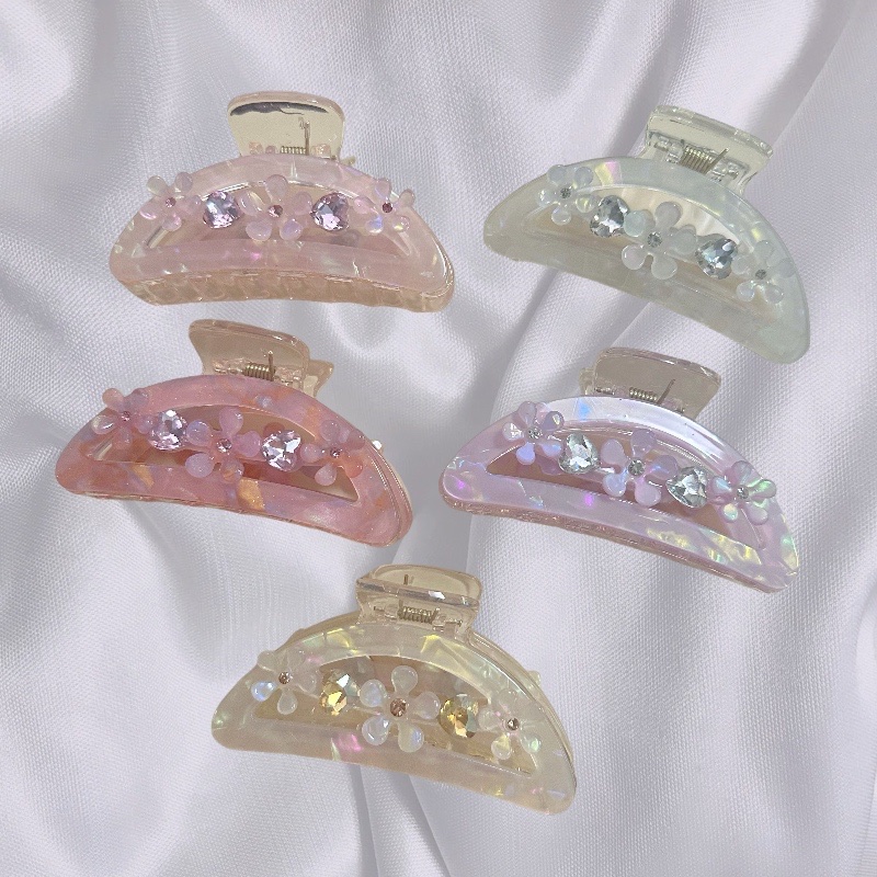 A sweet and delicate girl with a flower-shaped updo, a shark clip, and a light luxury color diamond grab clip hair accessory A sweet and delicate girl with a flower-shaped updo, a shark clip, and a light luxury color diamond grab clip hair accessory