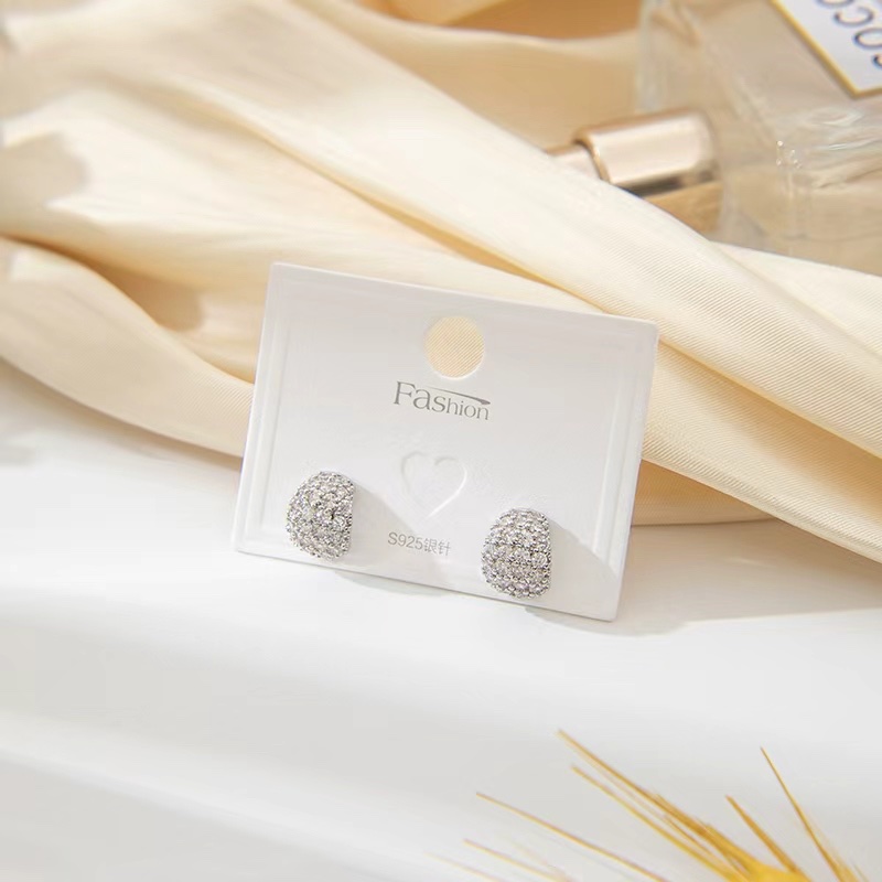 The stud earrings are popping detail image 2