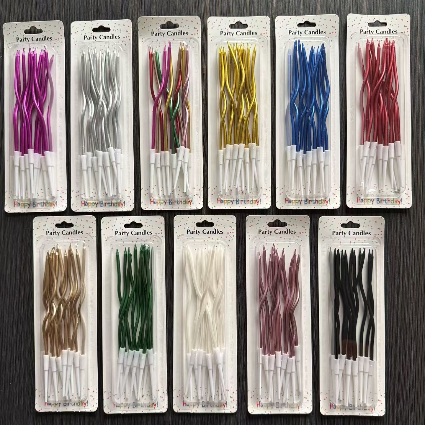 Twelve curved birthday candles in multiple colors