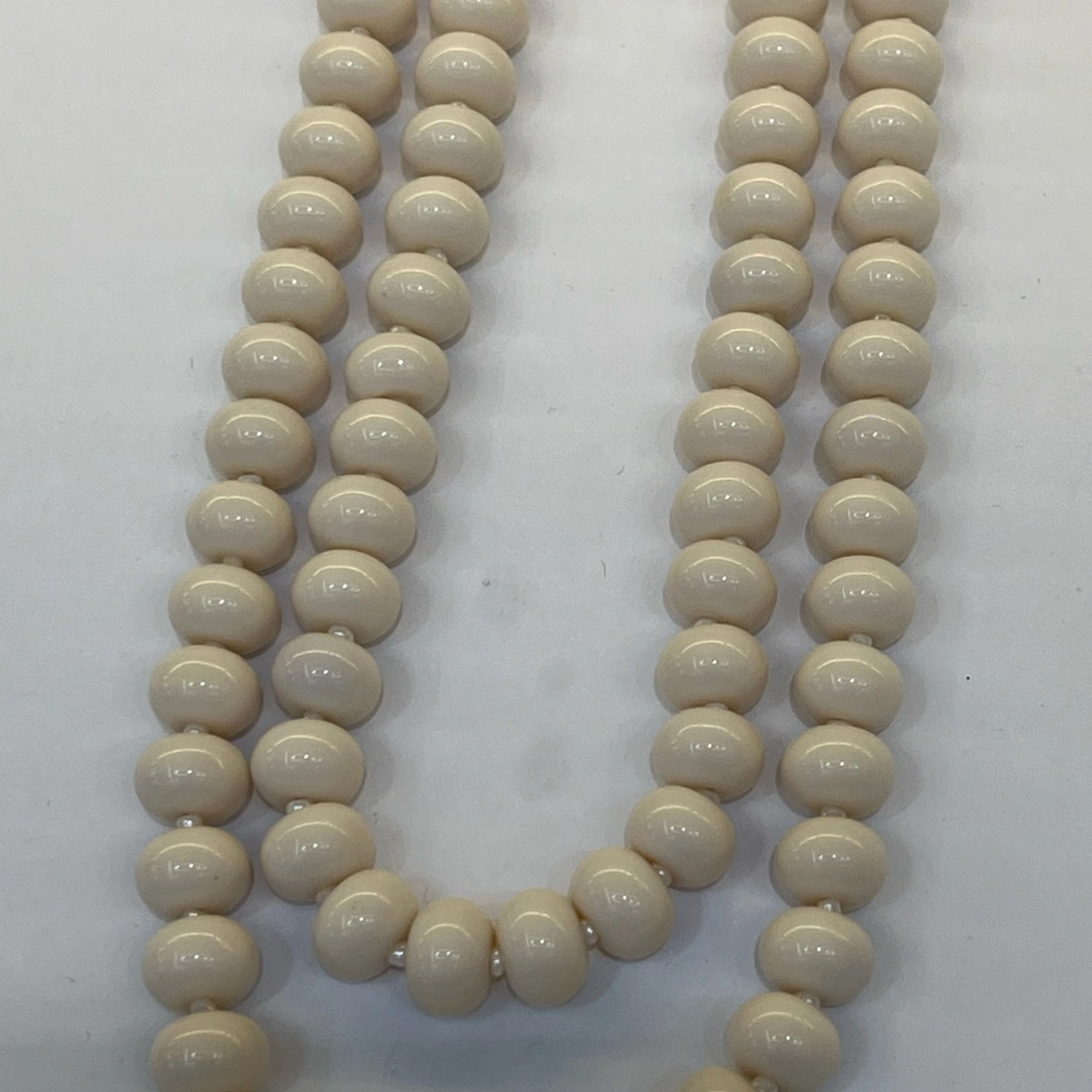 A fashionable and trendy stainless steel necklace with multiple sets of off-white glass beads detail image 2