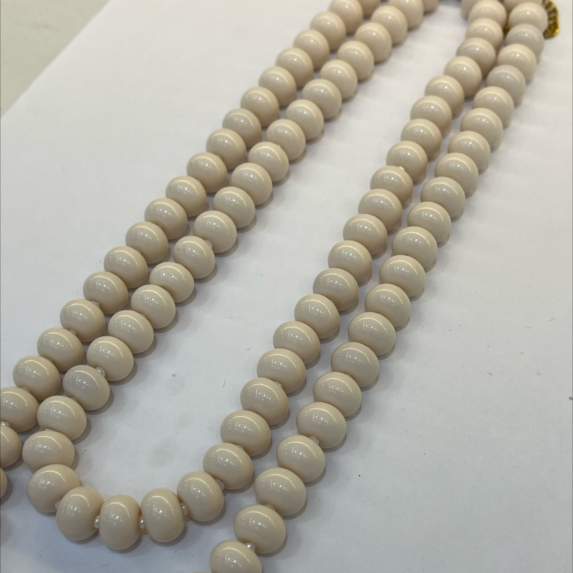 A fashionable and trendy stainless steel necklace with multiple sets of off-white glass beads detail image 3