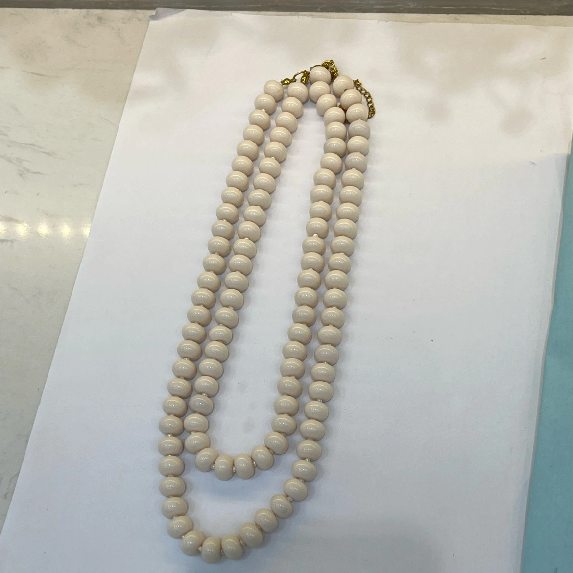 A fashionable and trendy stainless steel necklace with multiple sets of off-white glass beads detail image 5