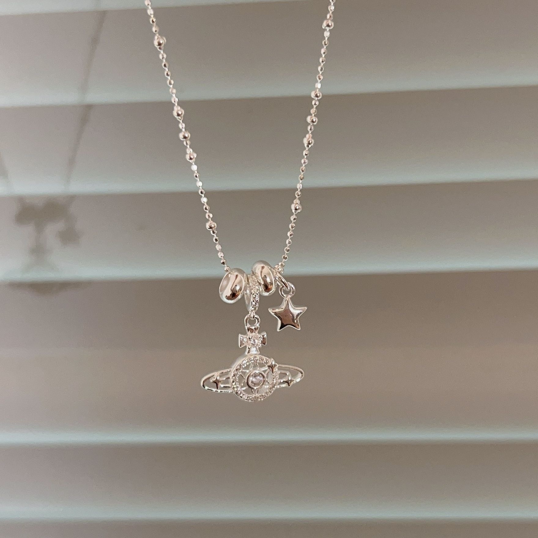 The Korean version of the S925 sterling silver Saturn necklace is a niche and fashionable design for women, with a high-end feel. It is a versatile collarbone chain Application Scenario