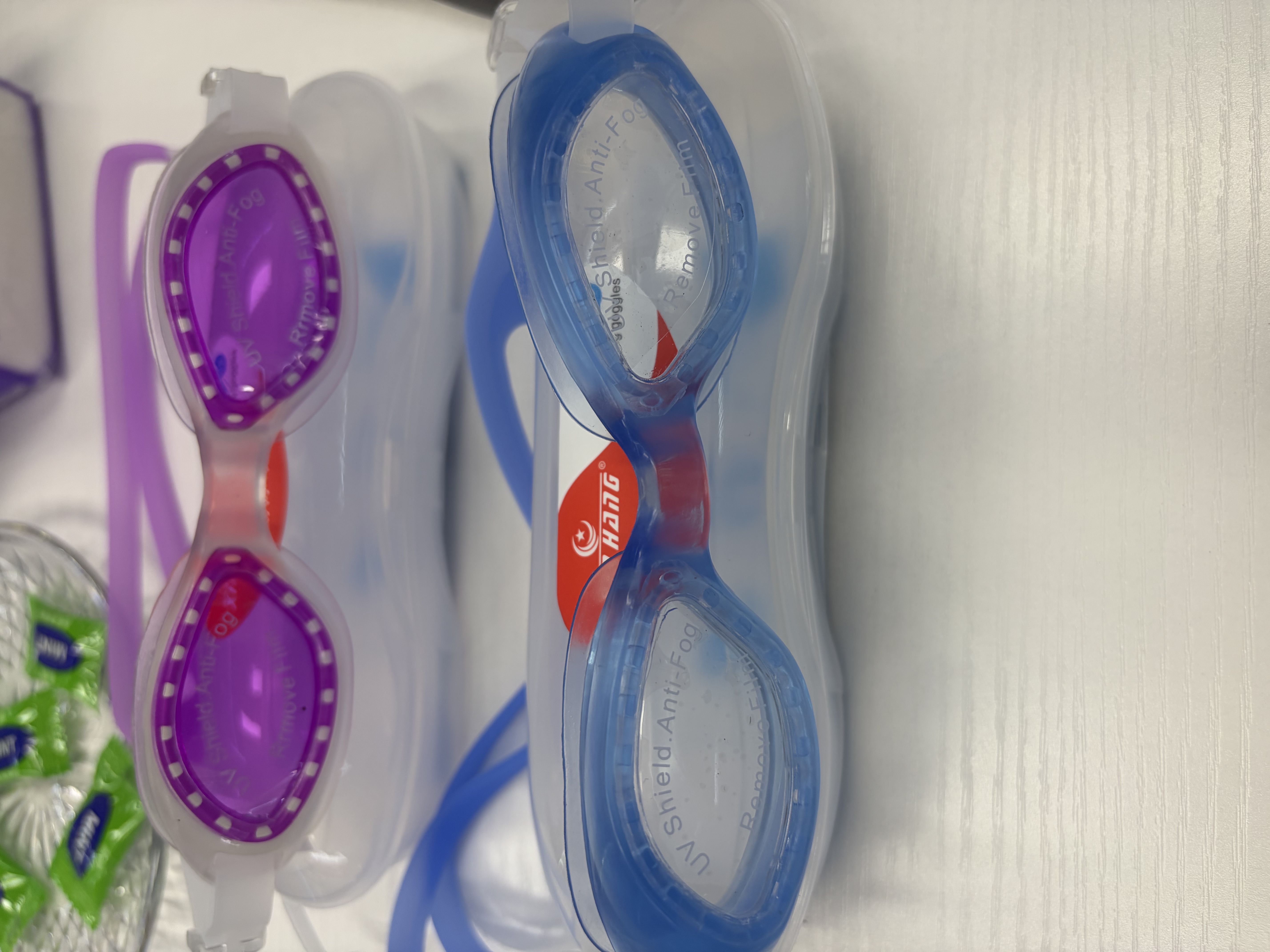 The purple and blue swimming goggles are unisex anti-fog silicone swimming goggles that fit comfortably detail image 1