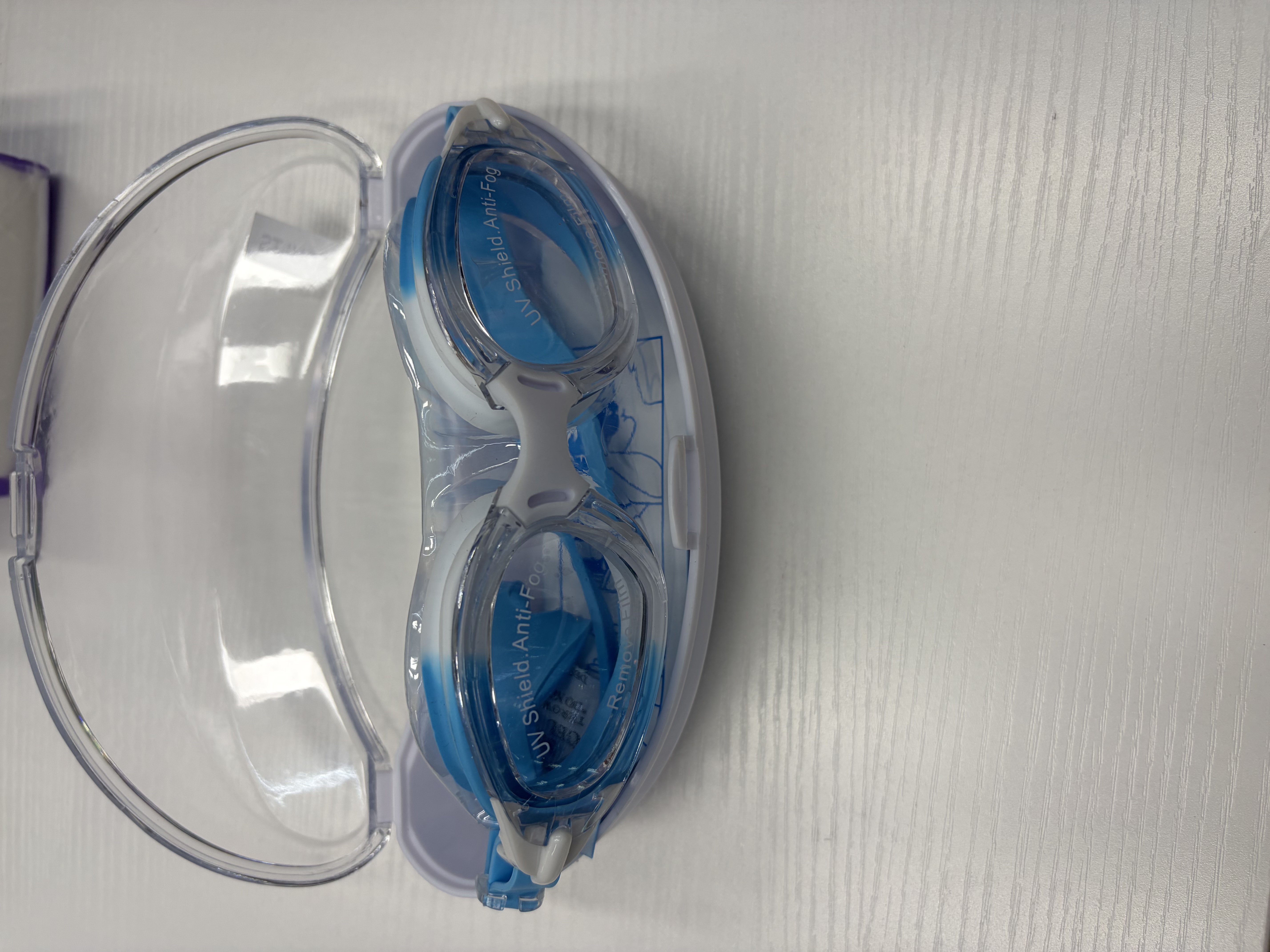 Blue and white swimming goggles with a transparent storage case, anti-fog and waterproof, comfortable and snug swimming glasses detail image 1