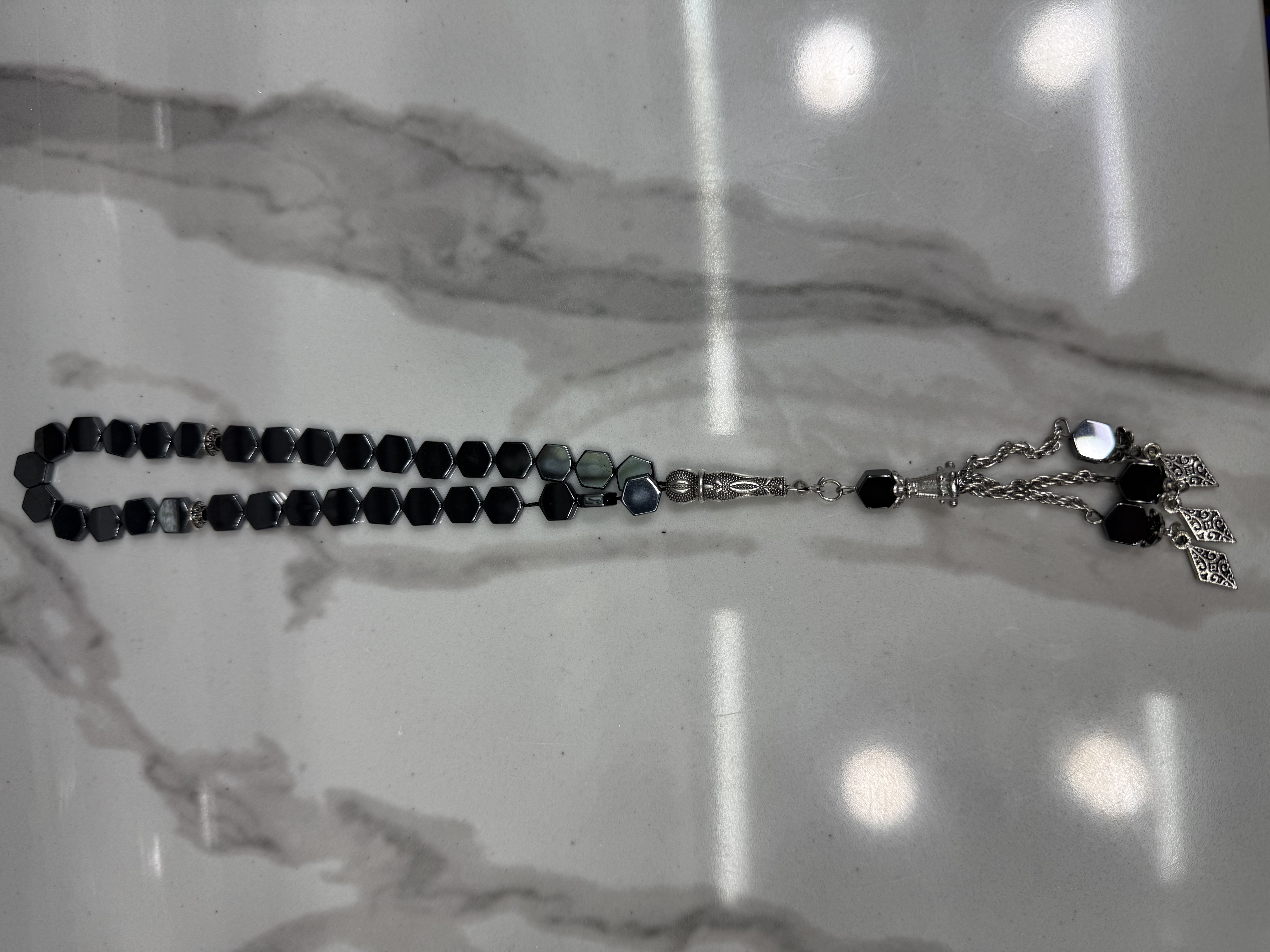33 Muslim black gallstone prayer beads, alloy whisker tips, 50 dozen per piece, 12 in a dozen. The price is for individual pieces