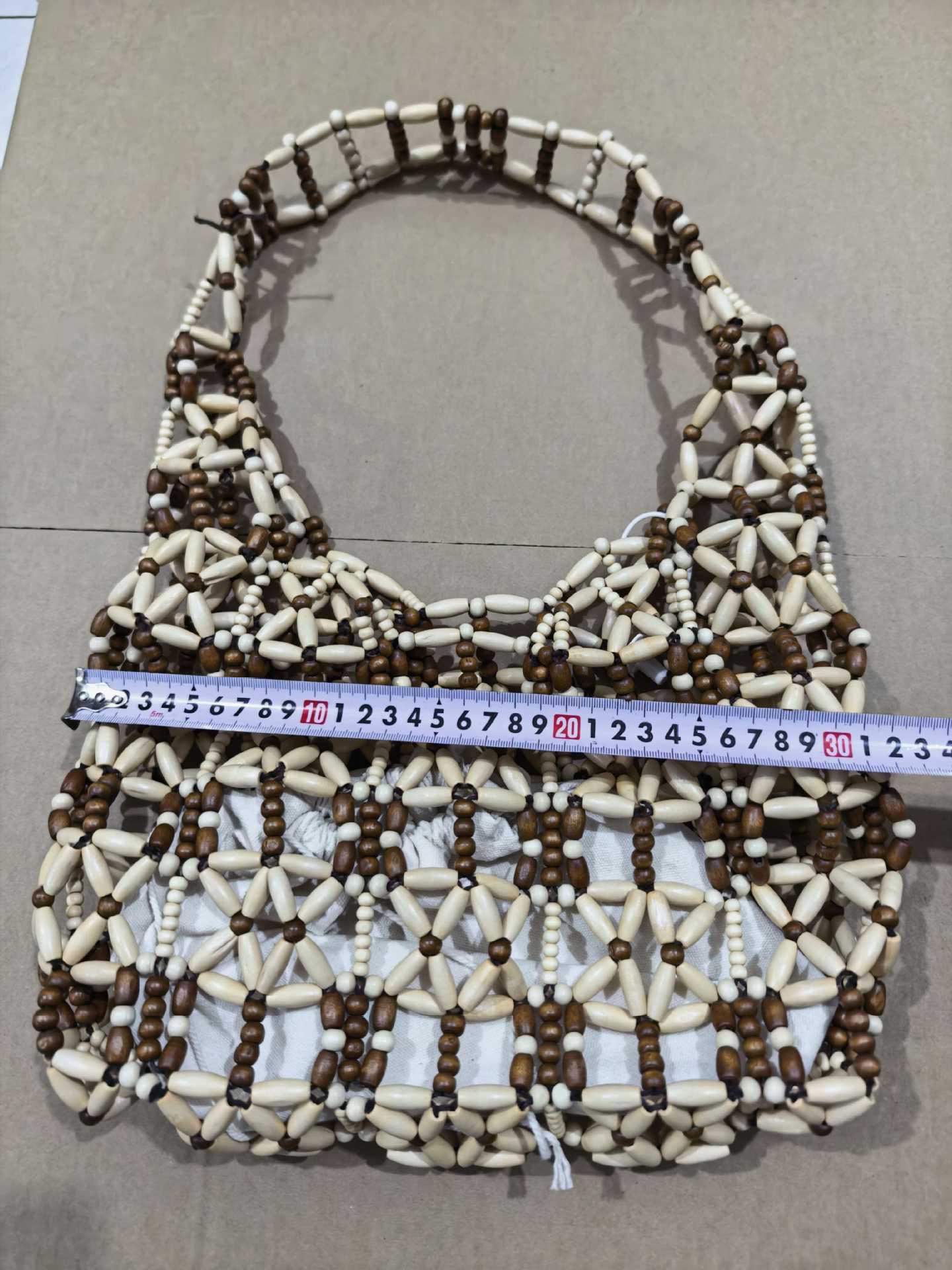 A new style of casual and versatile wooden beaded bag with a color-blocking and hollowed-out woven vacation beach bag and handcrafted beaded bag detail image 6