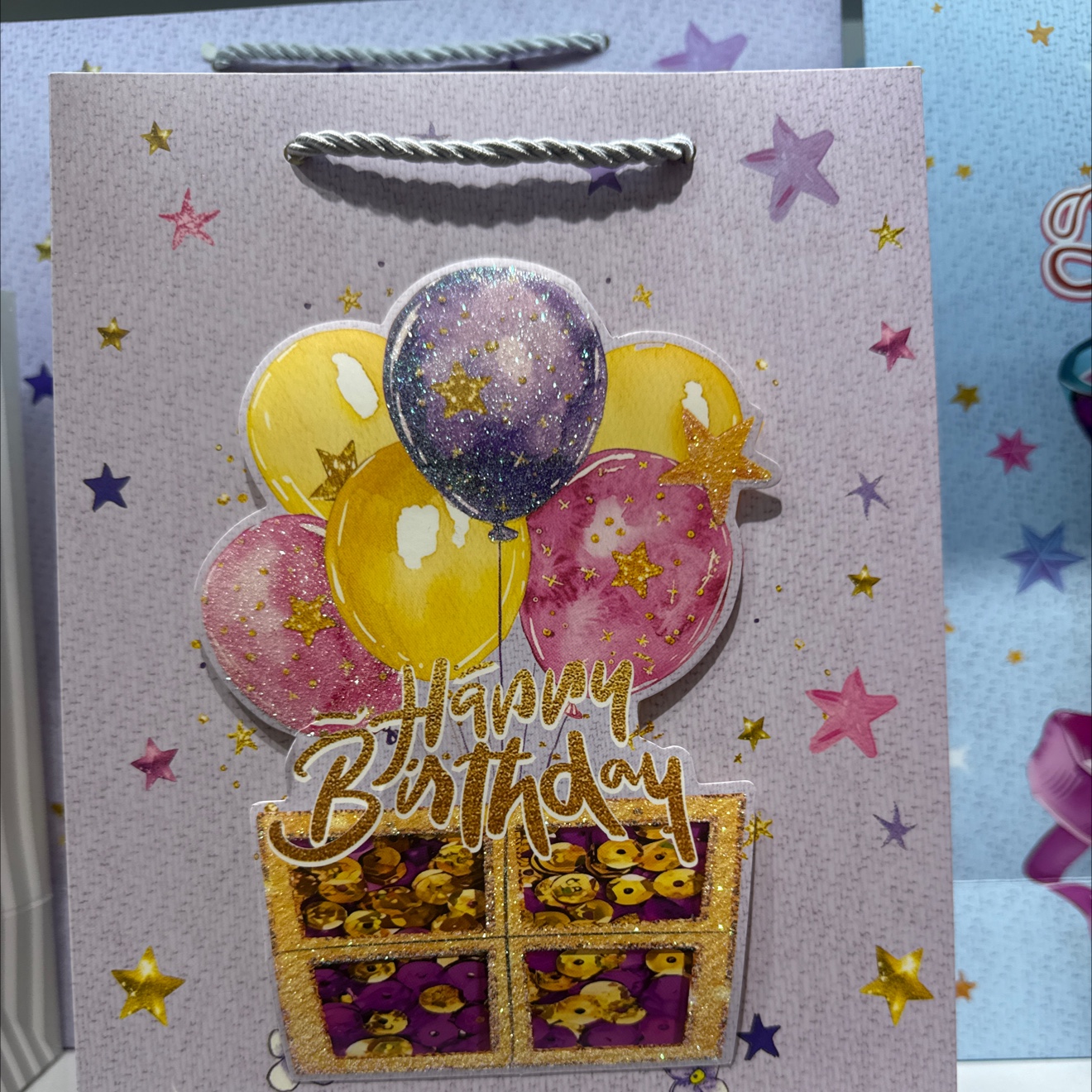 Purple star background gift bag, colorful balloons, golden blessing words, glitter decoration packaging box, souvenir packaging box, cultural and creative gift box full image