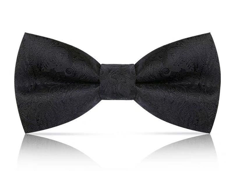 Groom with a bow tie, man in formal attire, best man with a bow tie, British fashion trend, high-end wedding, brothers in suits undefined
