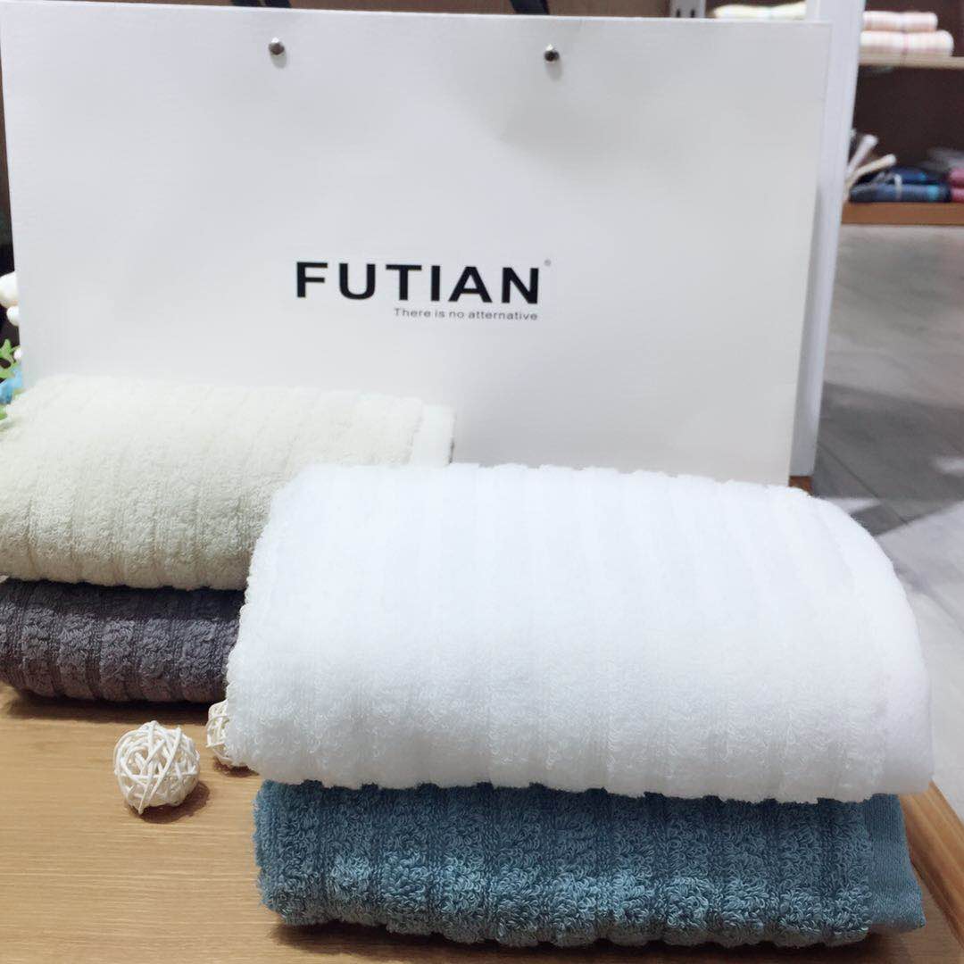 Happy couple smiling while holding their matching cotton face towels