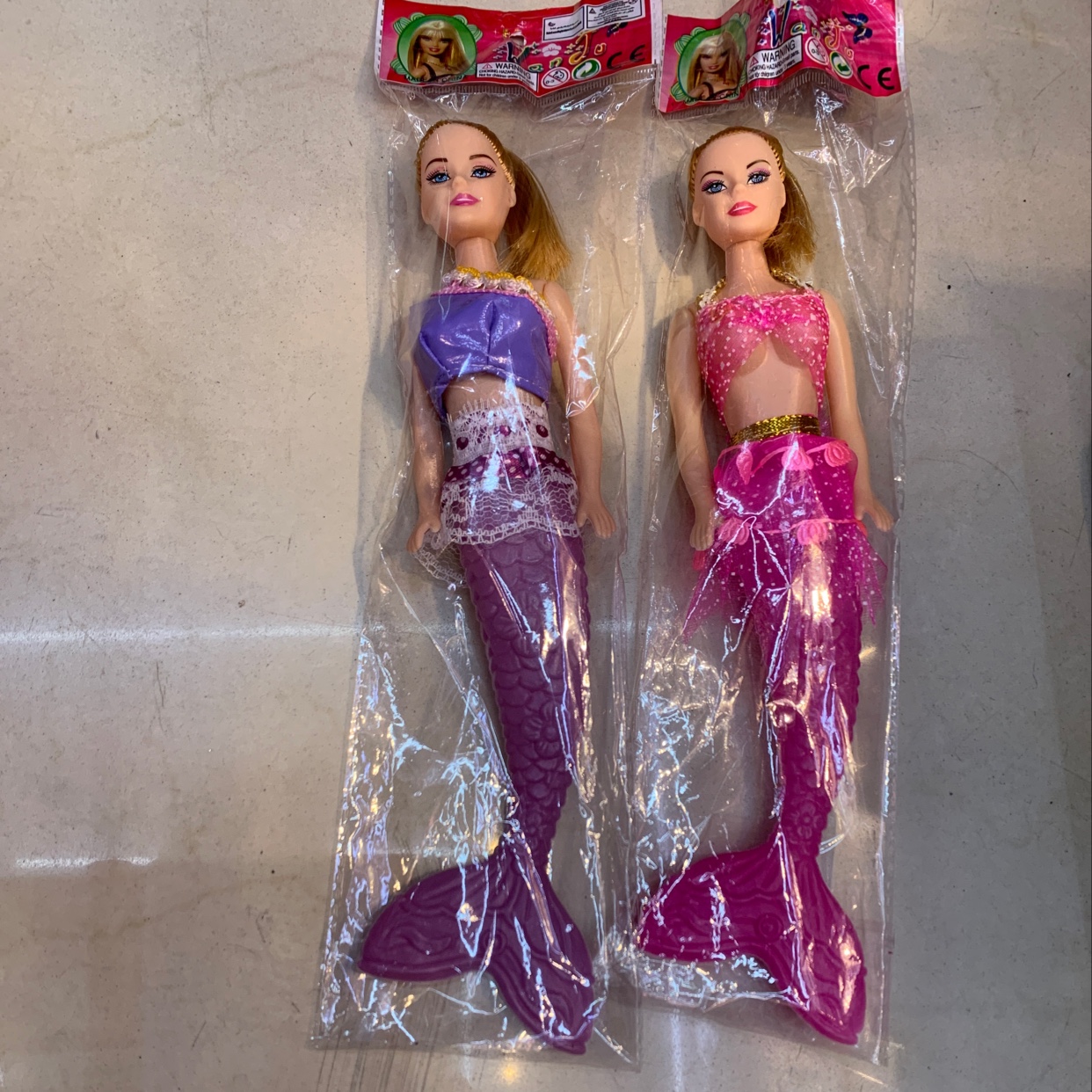 Mermaid Barbie dolls are mixed in different outfits and colors