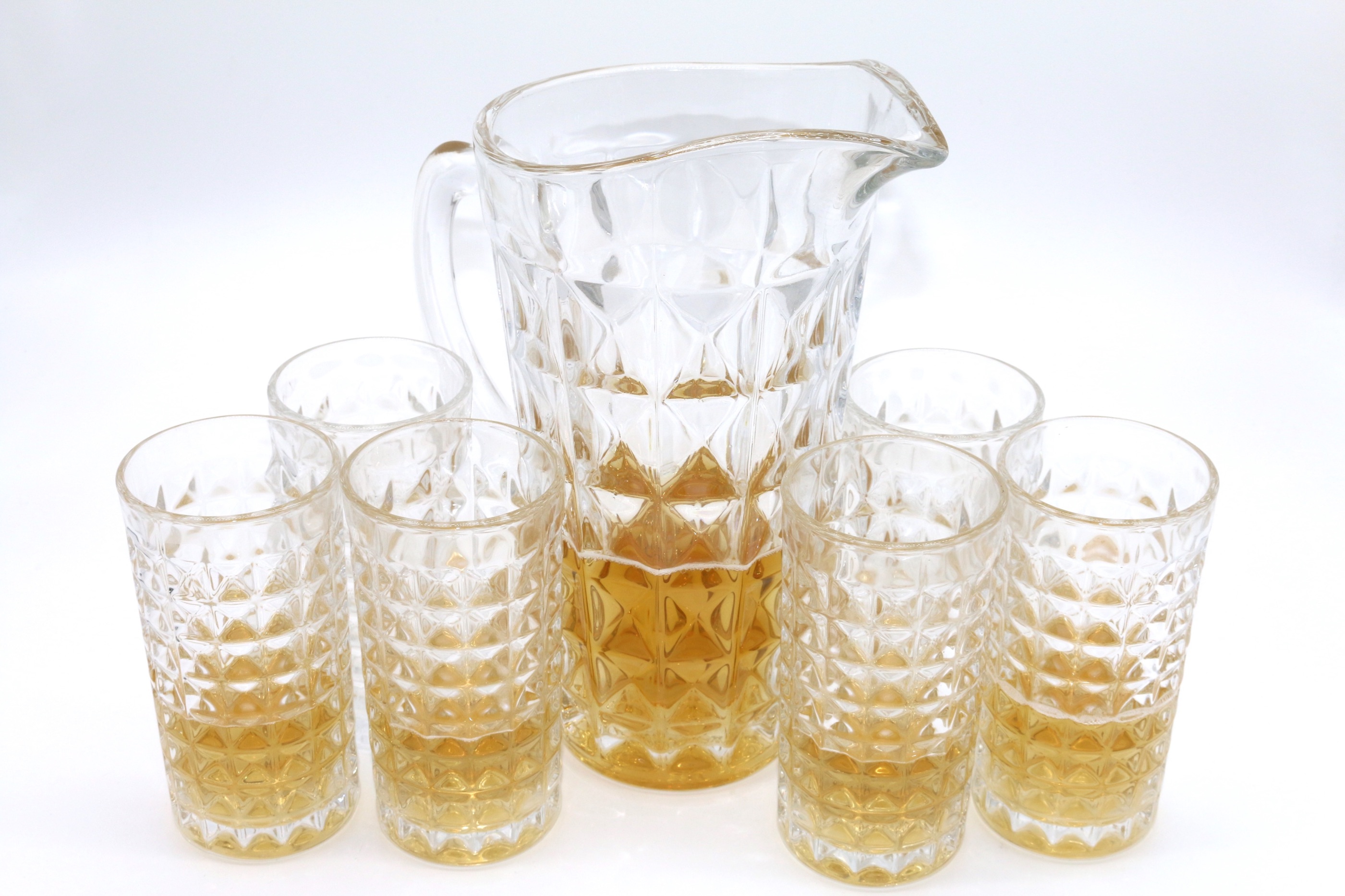 A glass water bottle set with six cups