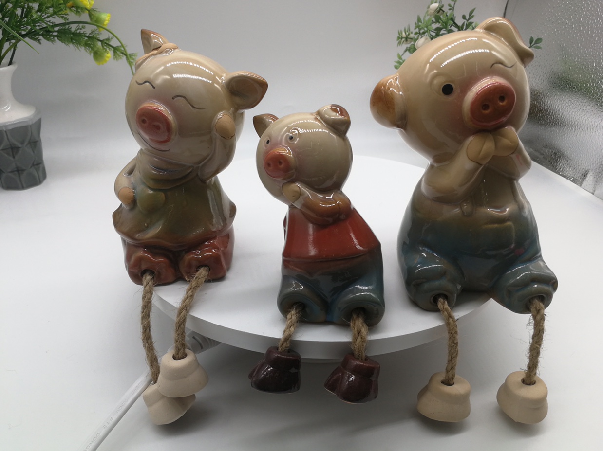 A family of three feet hanging ceramic cartoon pig thumbnail