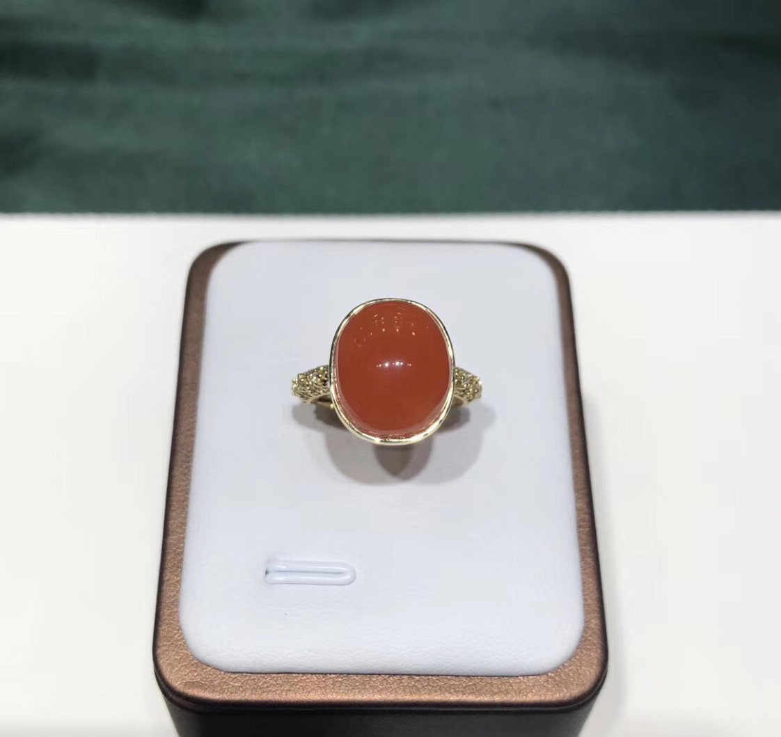 An 18k gold ring set with cherry red and south red