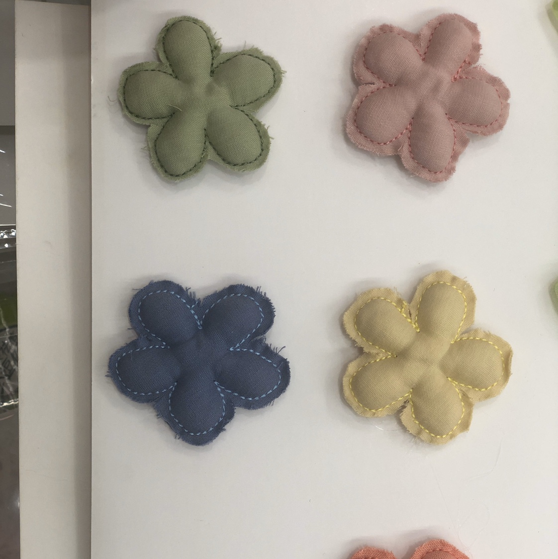 A single-color five-petal flower on cotton fabric