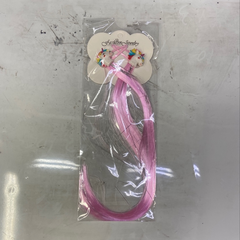 A children's unicorn wig with two hair clips
