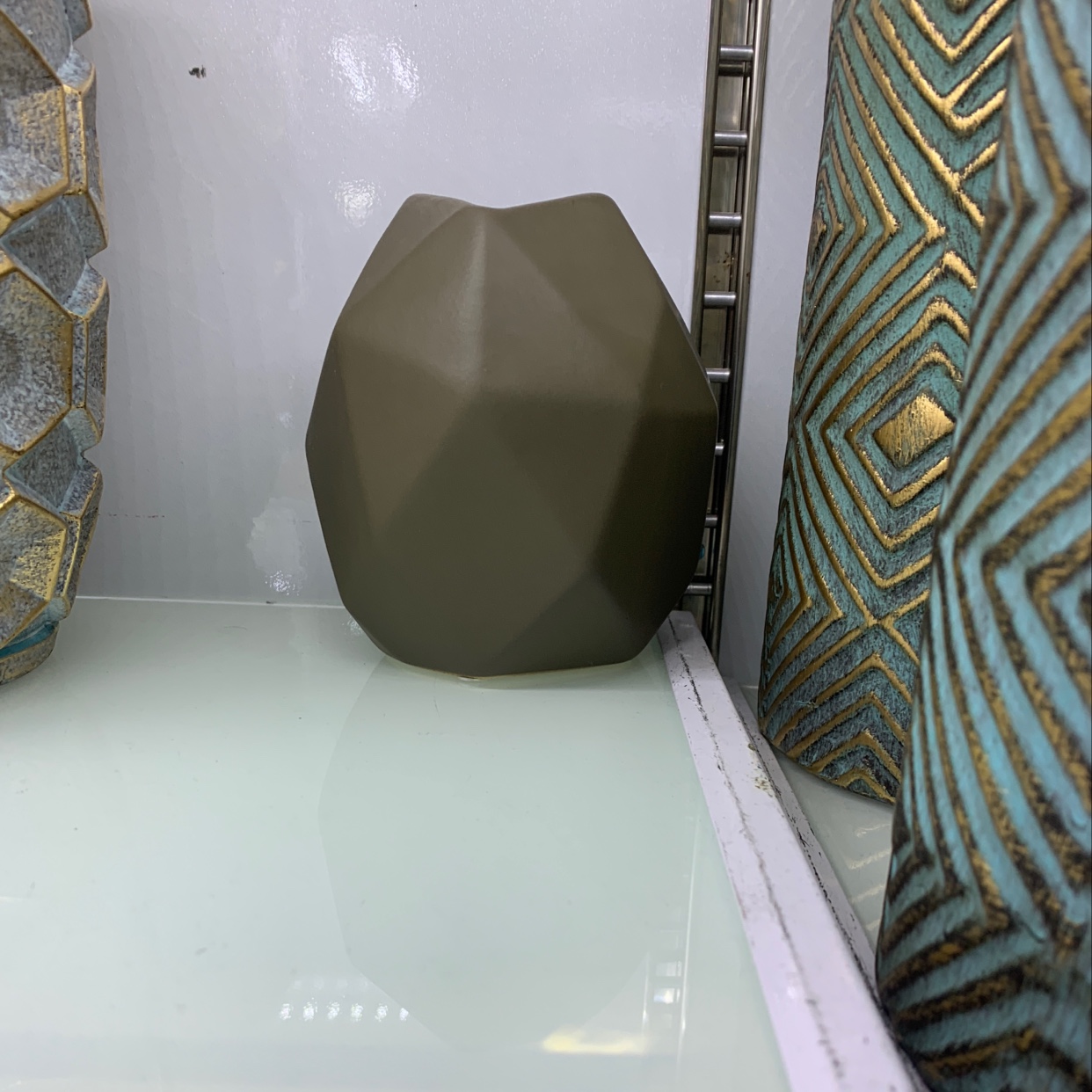 A small vase with many edges and corners