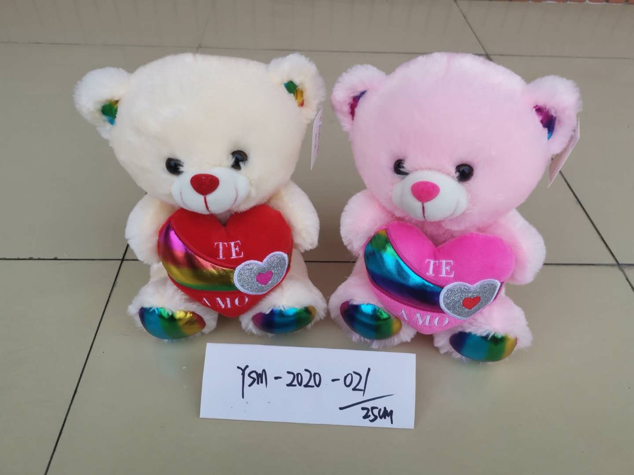 A stuffed bear gives a baby a hug thumbnail