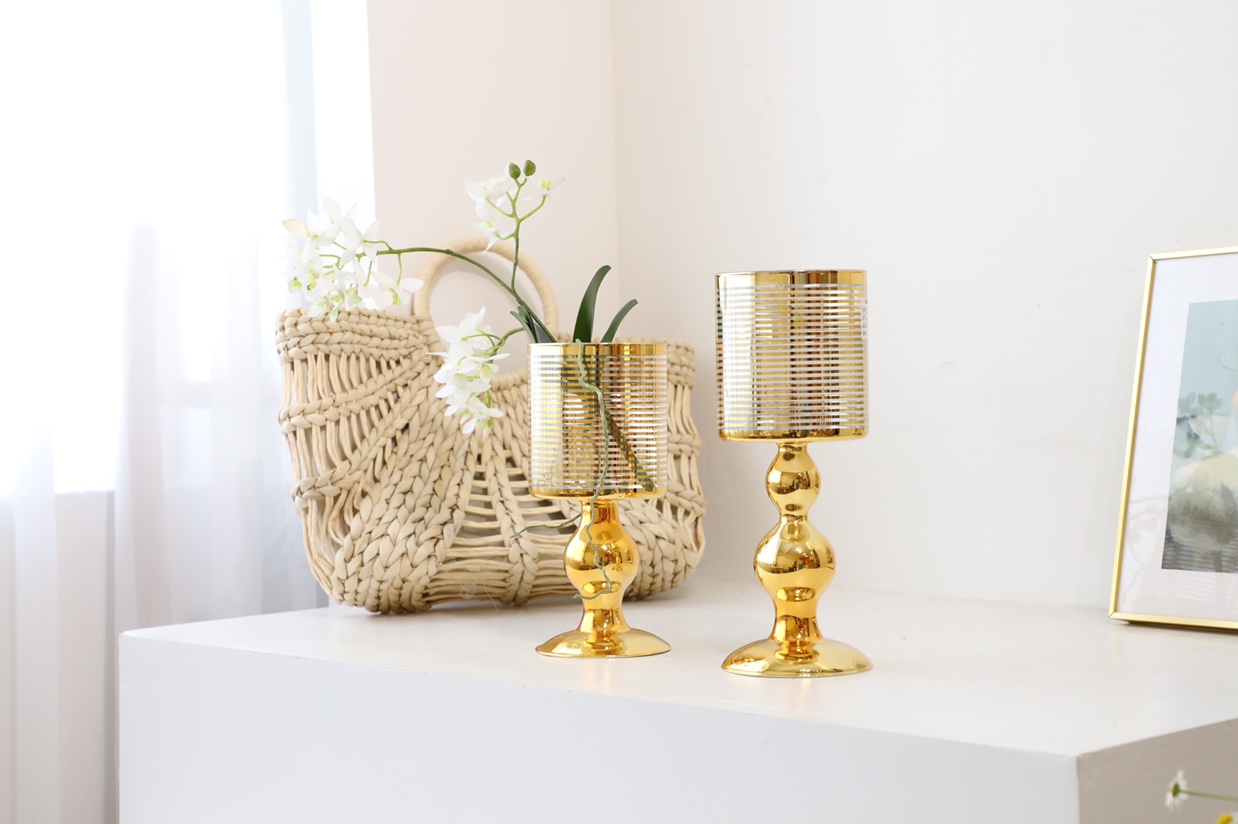 The tall candlestick is in gold and silver