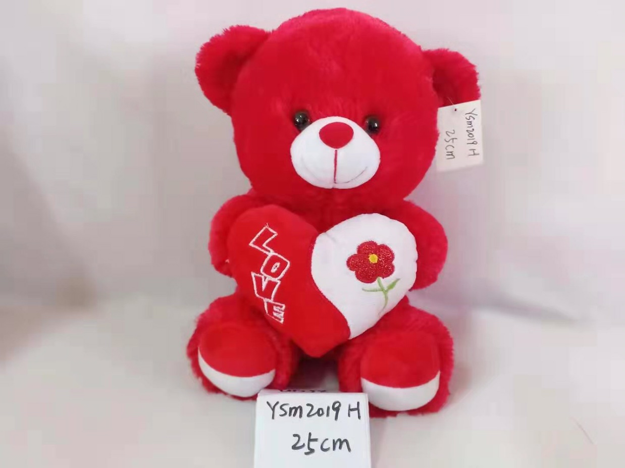 A cuddly bear gives a baby teddy bear