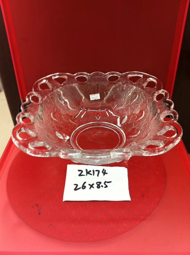 A glass home decoration item with four square holes, a fruit plate and storage tray