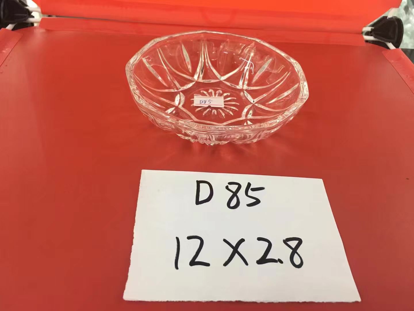 A glass semi-circular patterned candlestick ornament