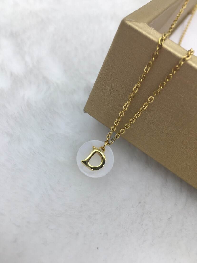 A woman with a letter and shell titanium steel necklace Application Scenario