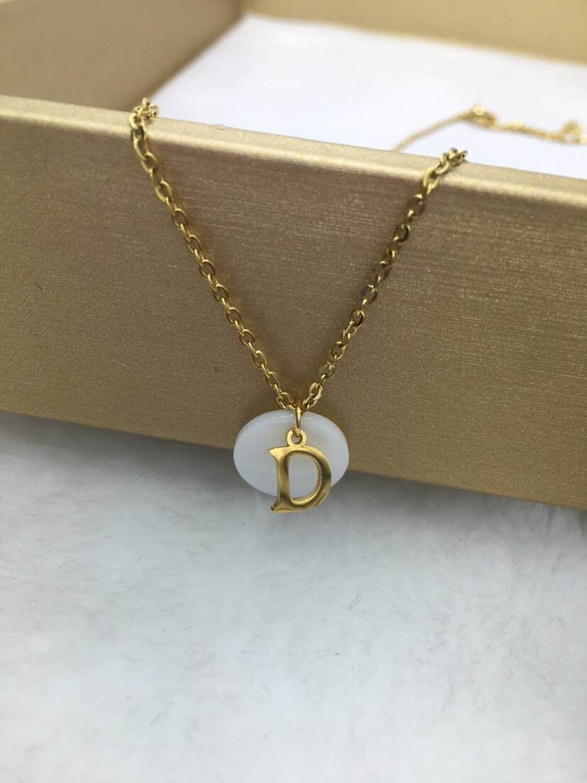 A woman with a letter and shell titanium steel necklace details Picture