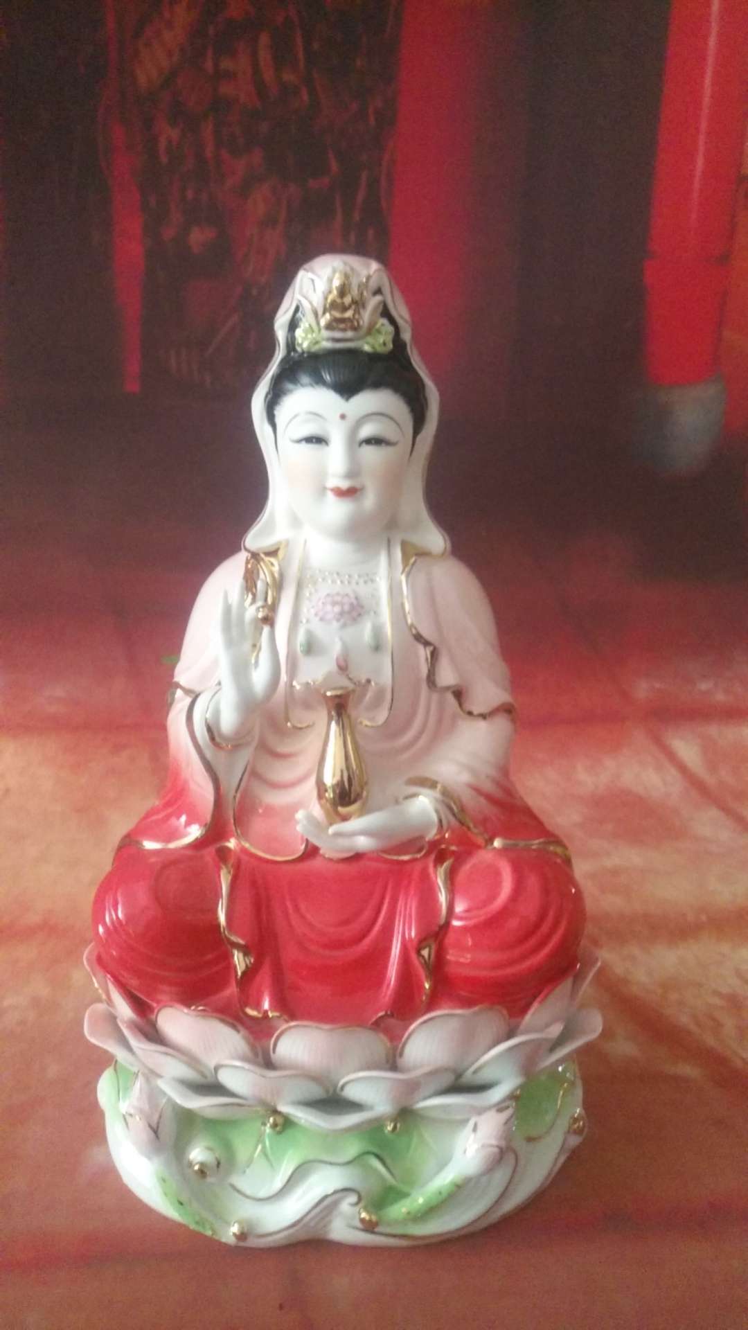 The auspicious Buddha is adorned with a jade porcelain lotus seated Guanyin