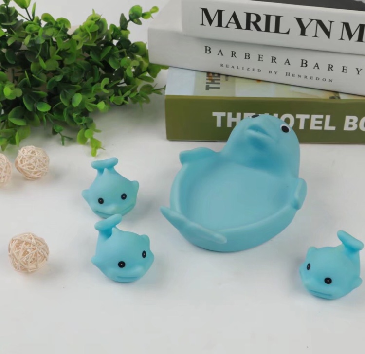 Three little dolphins in a rubber toy dolphin band