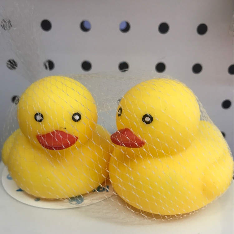 Two little yellow ducks, a water play toy and a vinyl toy for babies