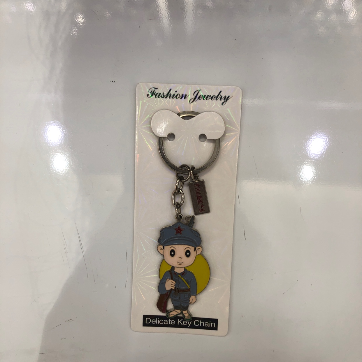 A keychain of a little Red Army boy from Jinggangshan with a dripping oil tag details Picture