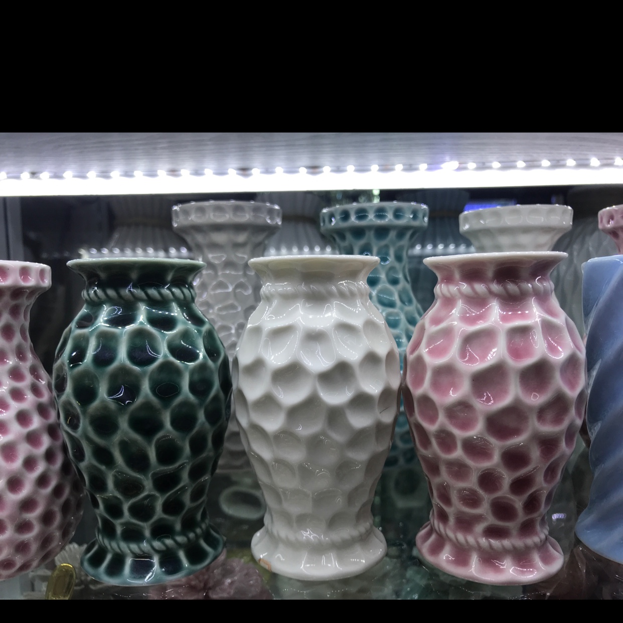 Small ceramic vases for home decoration are available in three colors