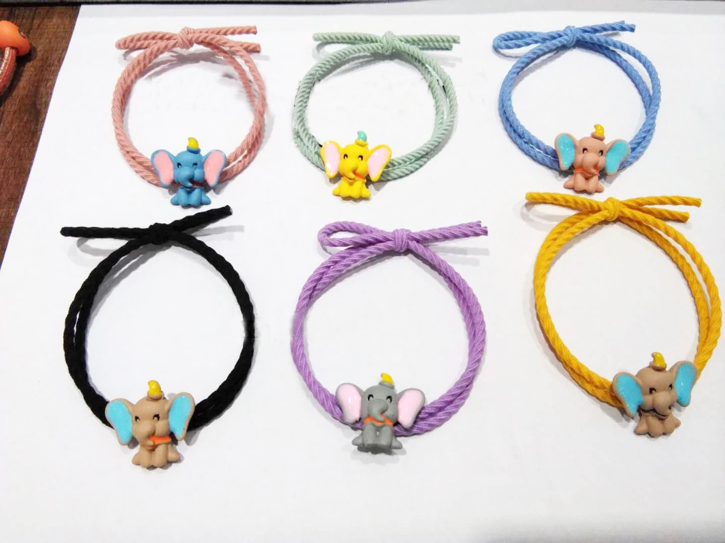 The four corners of the spray-painted Dumbo are twisted into loop-shaped rubber bands