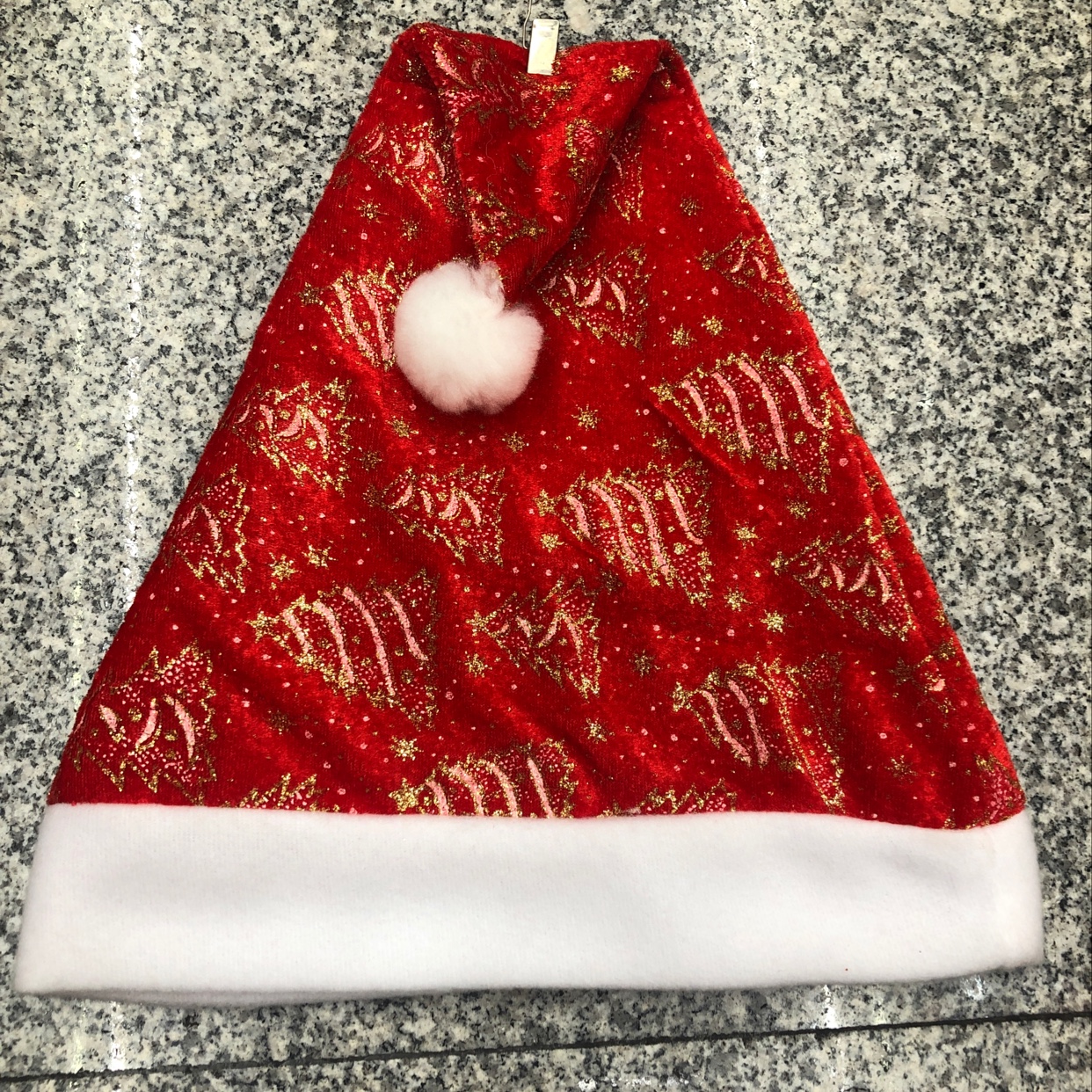 A woolen velvet Christmas hat with gold powder and fringed Christmas tree pattern