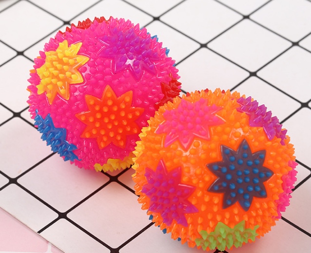 A flower ball a flashing toy with a whistle called a ball