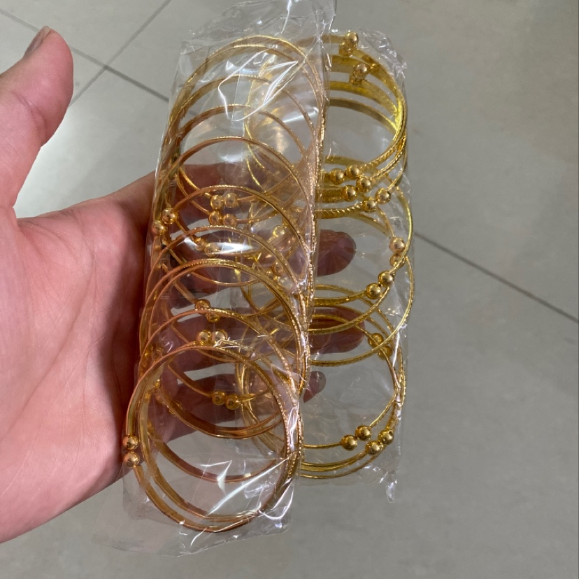 Open gold bangles inverted run - around products thumbnail
