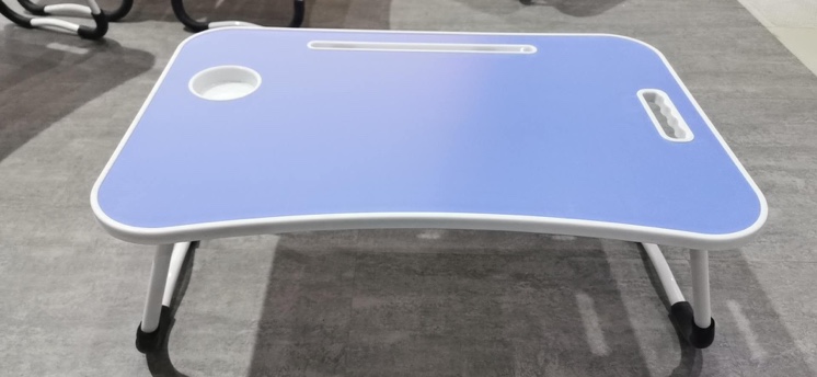 A small desk on the bed, a folding computer desk and a lazy desk undefined