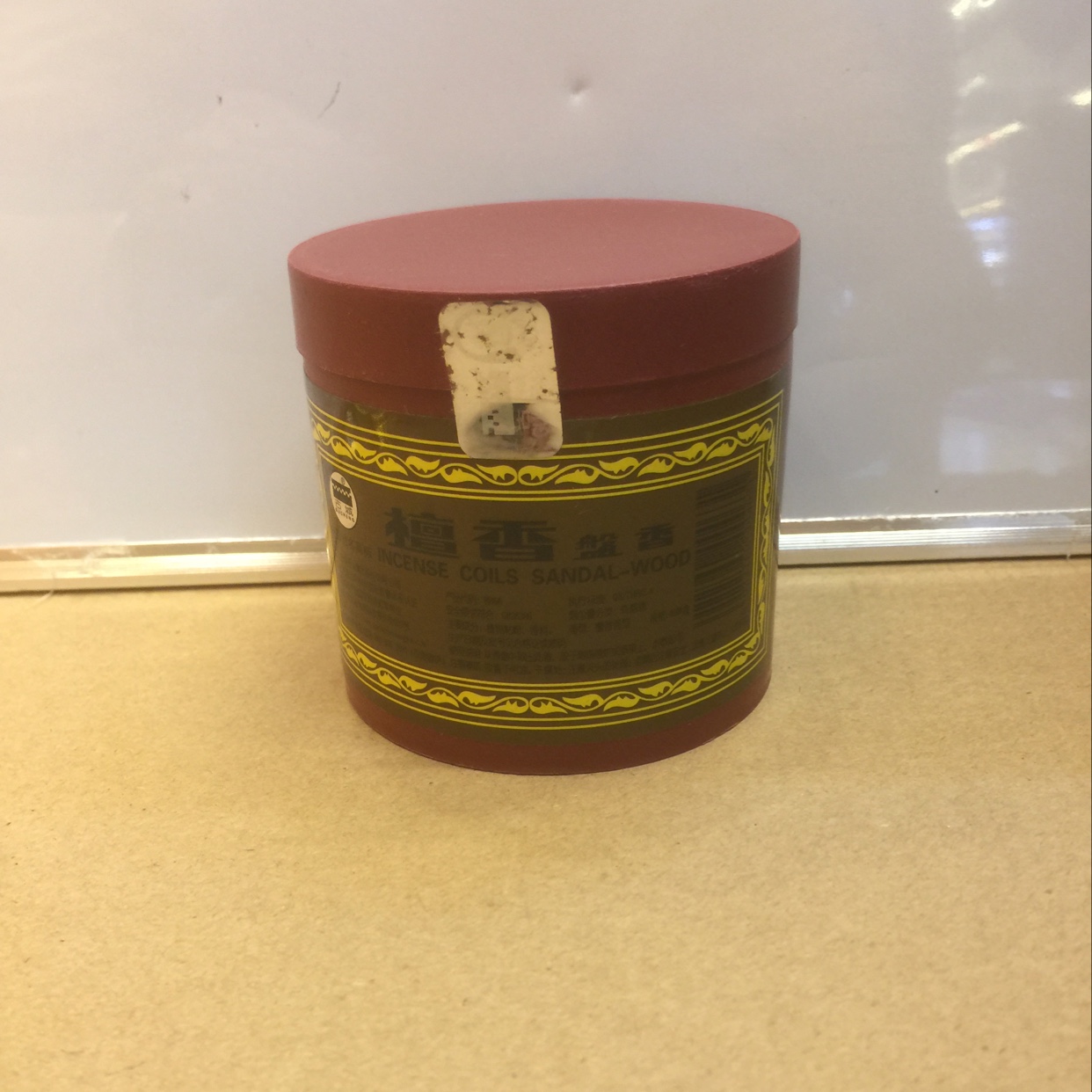 Small plastic sandalwood incense coil