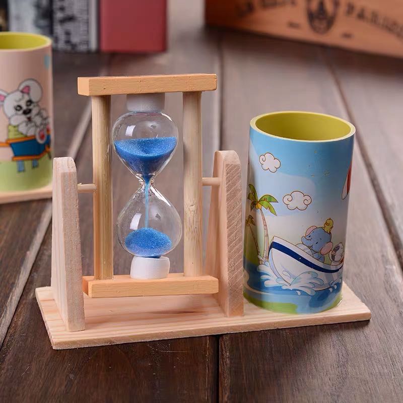 A small wooden colored hourglass resembles a pen holder at sea