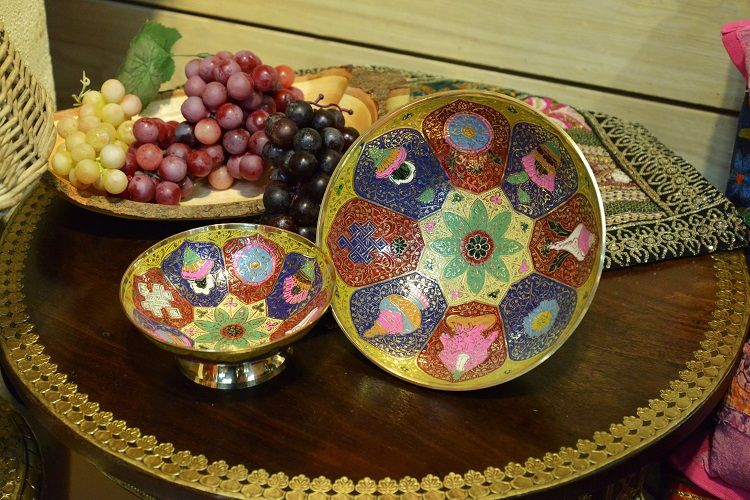 A large copper fruit plate with eight auspicious signs hand-painted in India