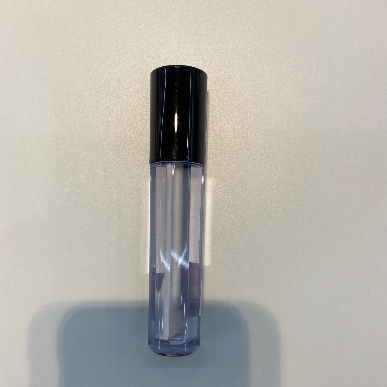 Black lip gloss tube with lid